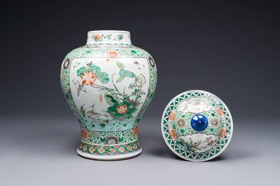 A pair of Chinese famille verte 'bird and flower' vases and covers, Kangxi mark, 19th C.