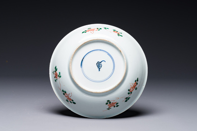 A Chinese famille verte 'qilin and falcon' plate, artemisia leaf mark, Kangxi