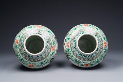 A pair of Chinese famille verte 'bird and flower' vases and covers, Kangxi mark, 19th C.