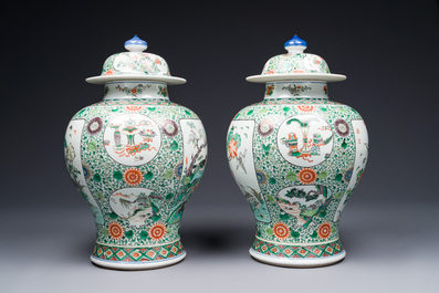 A pair of Chinese famille verte 'bird and flower' vases and covers, Kangxi mark, 19th C.