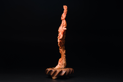 A Chinese red coral figure of Xiwangmu on wooden stand, 19/20th C.