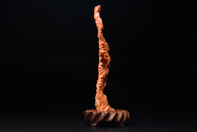 A Chinese red coral figure of Xiwangmu on wooden stand, 19/20th C.
