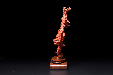 A large Chinese red coral group of female deities among clouds on wooden stand, 19/20th C.