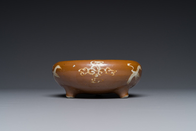 A rare Chinese Swatow slip-decorated brown-glazed tripod censer with cranes, Ming