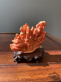 A Chinese red coral 'Eight Immortals' group on wooden stand, 19/20th C.