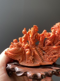 A Chinese red coral 'Eight Immortals' group on wooden stand, 19/20th C.