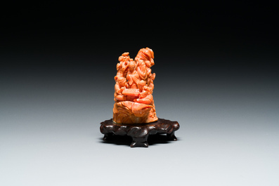 A Chinese red coral 'Eight Immortals' group on wooden stand, 19/20th C.
