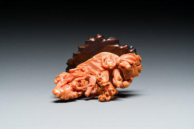 A Chinese red coral 'Eight Immortals' group on wooden stand, 19/20th C.