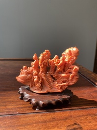 A Chinese red coral 'Eight Immortals' group on wooden stand, 19/20th C.