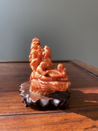 A Chinese red coral 'Eight Immortals' group on wooden stand, 19/20th C.