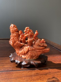 A Chinese red coral 'Eight Immortals' group on wooden stand, 19/20th C.