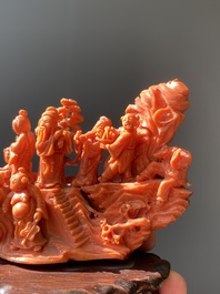 A Chinese red coral 'Eight Immortals' group on wooden stand, 19/20th C.