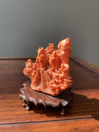 A Chinese red coral 'Eight Immortals' group on wooden stand, 19/20th C.