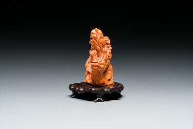 A Chinese red coral 'Eight Immortals' group on wooden stand, 19/20th C.