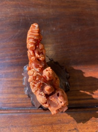 A Chinese red coral 'Eight Immortals' group on wooden stand, 19/20th C.