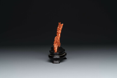 A Chinese red coral 'Eight Immortals' group on wooden stand, 19/20th C.