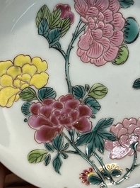 A pair of Chinese famille rose 'peony' cups and saucers, Yongzheng