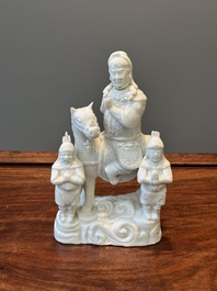 A Chinese Dehua blanc de Chine group of Guandi on horseback and two attendants, Kangxi
