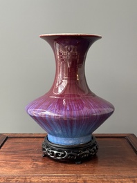 A Chinese flamb&eacute;-glazed vase on a wooden stand, 19th C.