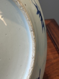 Een Chinese blauw-witte theepot met landschapsdecor en een schotel met kostbaarheden, 19e eeuw