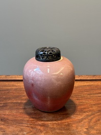 A Chinese monochrome copper-red-glazed ginger jar with a reticulated wooden cover, 18/19th C.