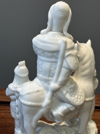 A Chinese Dehua blanc de Chine group of Guandi on horseback and two attendants, Kangxi