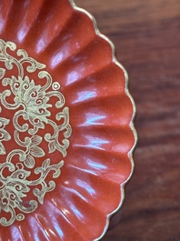 A Chinese coral-red-glazed gilt-decorated 'lotus scroll' saucer, Jiaqing mark, Republic