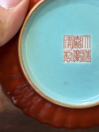 A Chinese coral-red-glazed gilt-decorated 'lotus scroll' saucer, Jiaqing mark, Republic