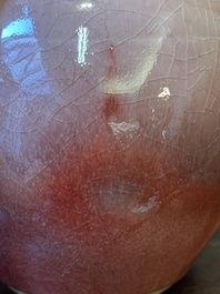 A Chinese monochrome copper-red-glazed ginger jar with a reticulated wooden cover, 18/19th C.