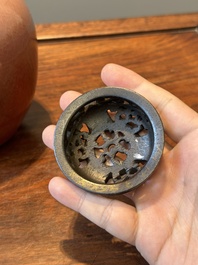 A Chinese monochrome copper-red-glazed ginger jar with a reticulated wooden cover, 18/19th C.
