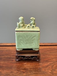A Chinese Longquan celadon rectangular censer and cover on wooden stand, Ming
