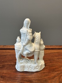 A Chinese Dehua blanc de Chine group of Guandi on horseback and two attendants, Kangxi