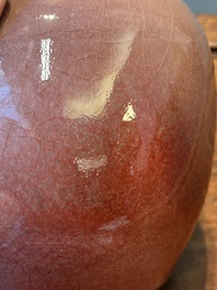 A Chinese monochrome copper-red-glazed ginger jar with a reticulated wooden cover, 18/19th C.