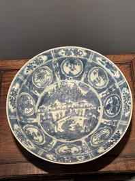 A large Chinese blue and white Swatow dish with a lobster and a carp at a fishing village, Ming