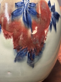 A Chinese celadon-ground blue, white and copper-red ginger jar with reticulated wooden cover and stand, 18th C.