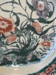 A Chinese famille verte caf&eacute;-au-lait ground plate and a monochrome white plate, Kangxi