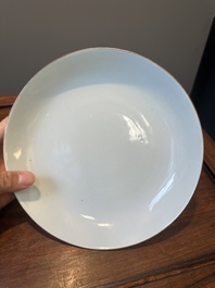 A Chinese famille verte caf&eacute;-au-lait ground plate and a monochrome white plate, Kangxi