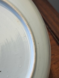 A Chinese famille verte caf&eacute;-au-lait ground plate and a monochrome white plate, Kangxi