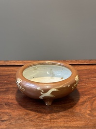 A rare Chinese Swatow slip-decorated brown-glazed tripod censer with cranes, Ming