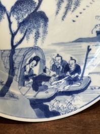 A Chinese blue and white plate with a breastfeeding woman and fishermen on boats, Chenghua mark, Kangxi
