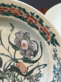 A Chinese famille verte caf&eacute;-au-lait ground plate and a monochrome white plate, Kangxi