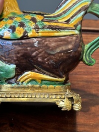 A pair of Chinese sancai-glazed chicken ewers mounted as candleholders with gilt bronze, Kangxi