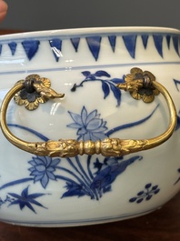A Chinese blue and white covered bowl with floral design and gilt bronze mounts, Transitional period