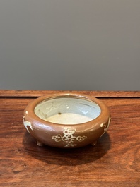 A rare Chinese Swatow slip-decorated brown-glazed tripod censer with cranes, Ming