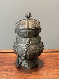 A Chinese bronze ritual wine vessel and cover, 'you', Yuan/Ming