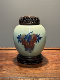 A Chinese celadon-ground blue, white and copper-red ginger jar with reticulated wooden cover and stand, 18th C.