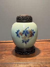 A Chinese celadon-ground blue, white and copper-red ginger jar with reticulated wooden cover and stand, 18th C.