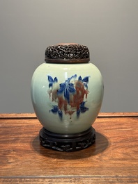 A Chinese celadon-ground blue, white and copper-red ginger jar with reticulated wooden cover and stand, 18th C.