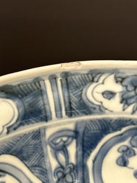 A large Chinese blue and white Swatow dish with a lobster and a carp at a fishing village, Ming