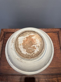 A large Chinese blue and white Swatow dish with a lobster and a carp at a fishing village, Ming